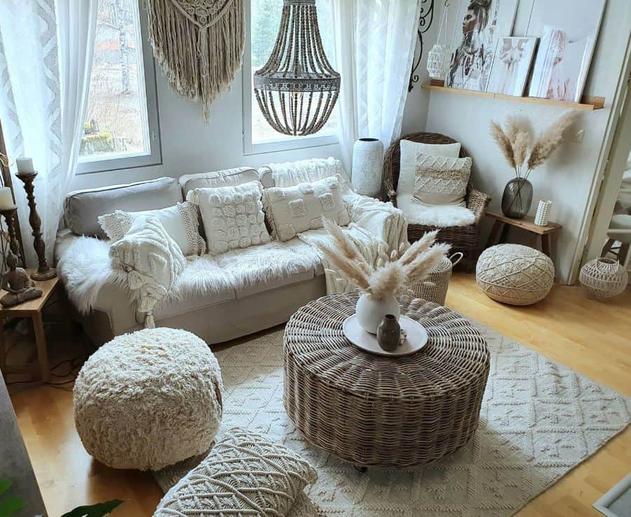 Neutral bohemian living room with textured pillows, wicker furniture, and pampas grass decor.