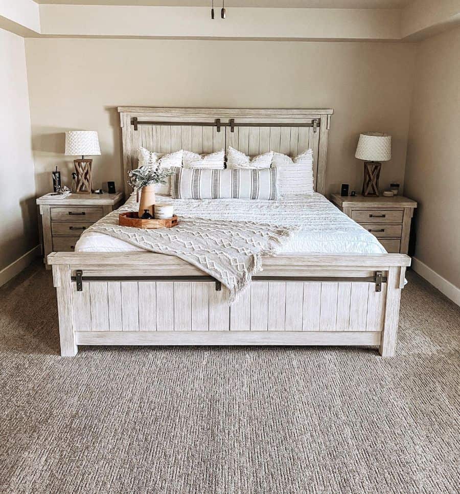 Farmhouse-style cozy bedroom with a wooden bed, white bedding, and matching nightstands with lamps