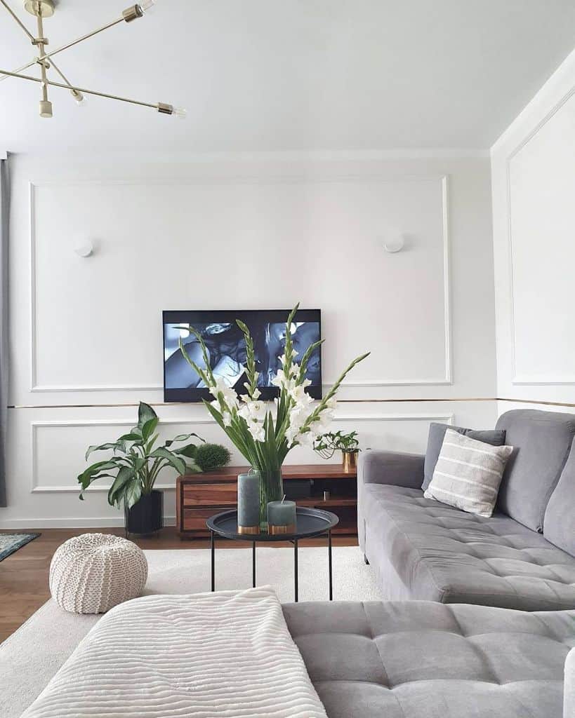 large minimalist white living room with gray sofa