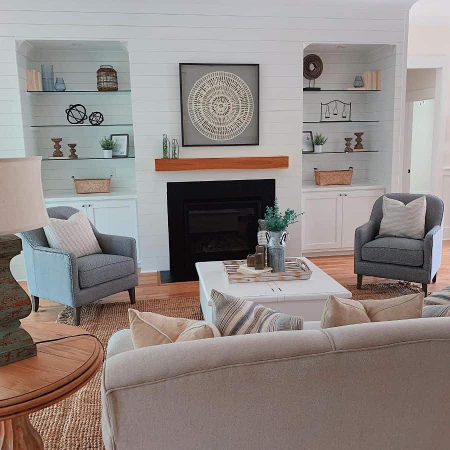 modern farmhouse living room gray lounge chairs beige sofa fireplace recessed shelves