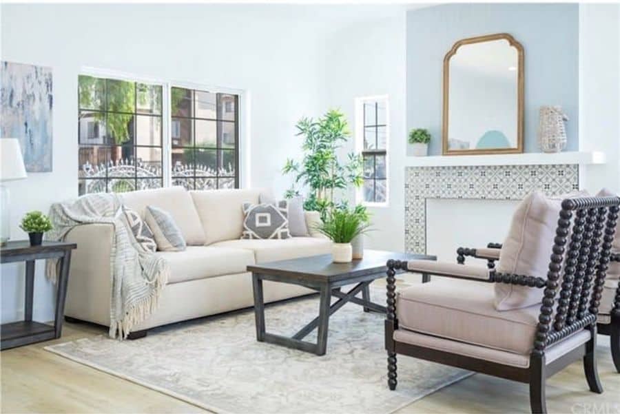 modern farmhouse living room blue walls gold trim mirror white sofa accent chairs