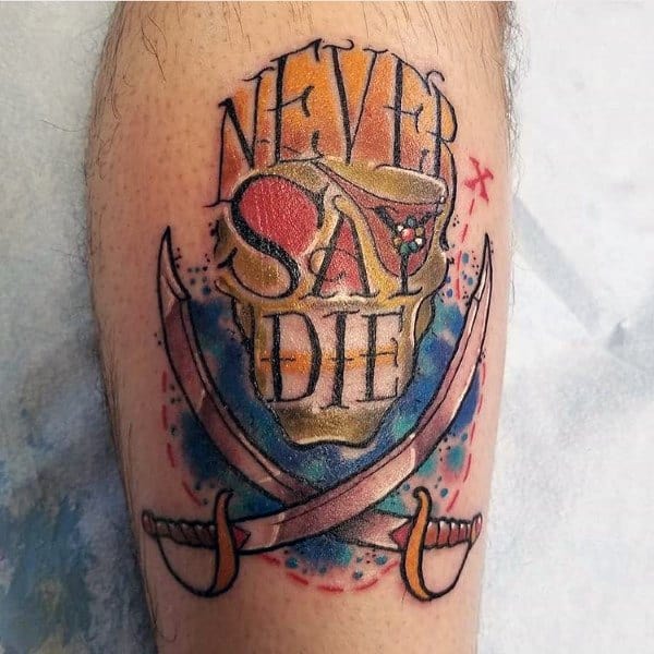 Colorful tattoo inspired by The Goonies, featuring a skull with the phrase "Never Say Die" and two crossed pirate swords with a watercolor effect.