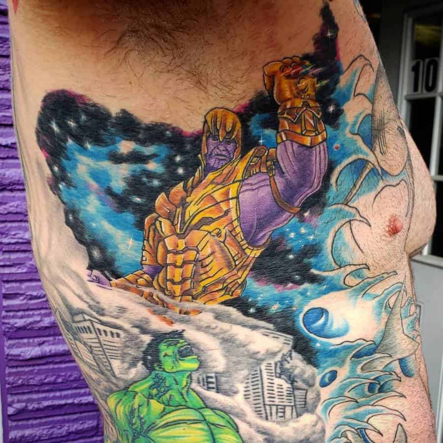 Epic Thanos tattoo with the Infinity Gauntlet raised, set against a cosmic backdrop, with Hulk emerging from smoke below