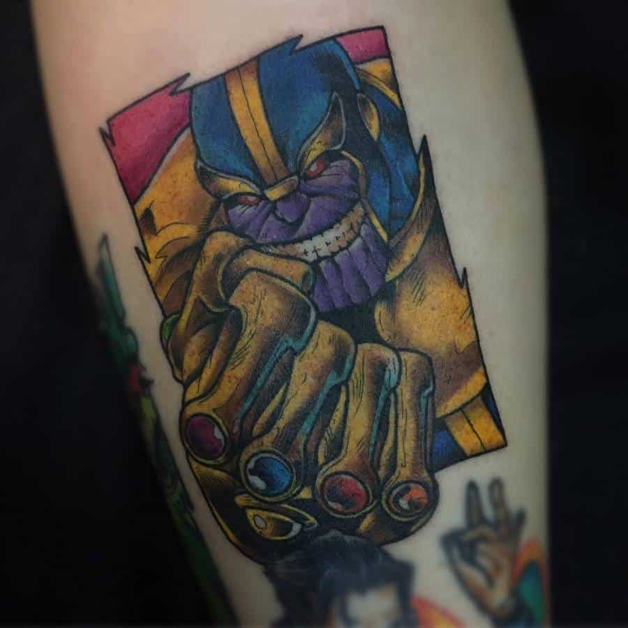 Bold Thanos tattoo with a menacing grin, showcasing the Infinity Gauntlet with all six stones in a vibrant comic-style design