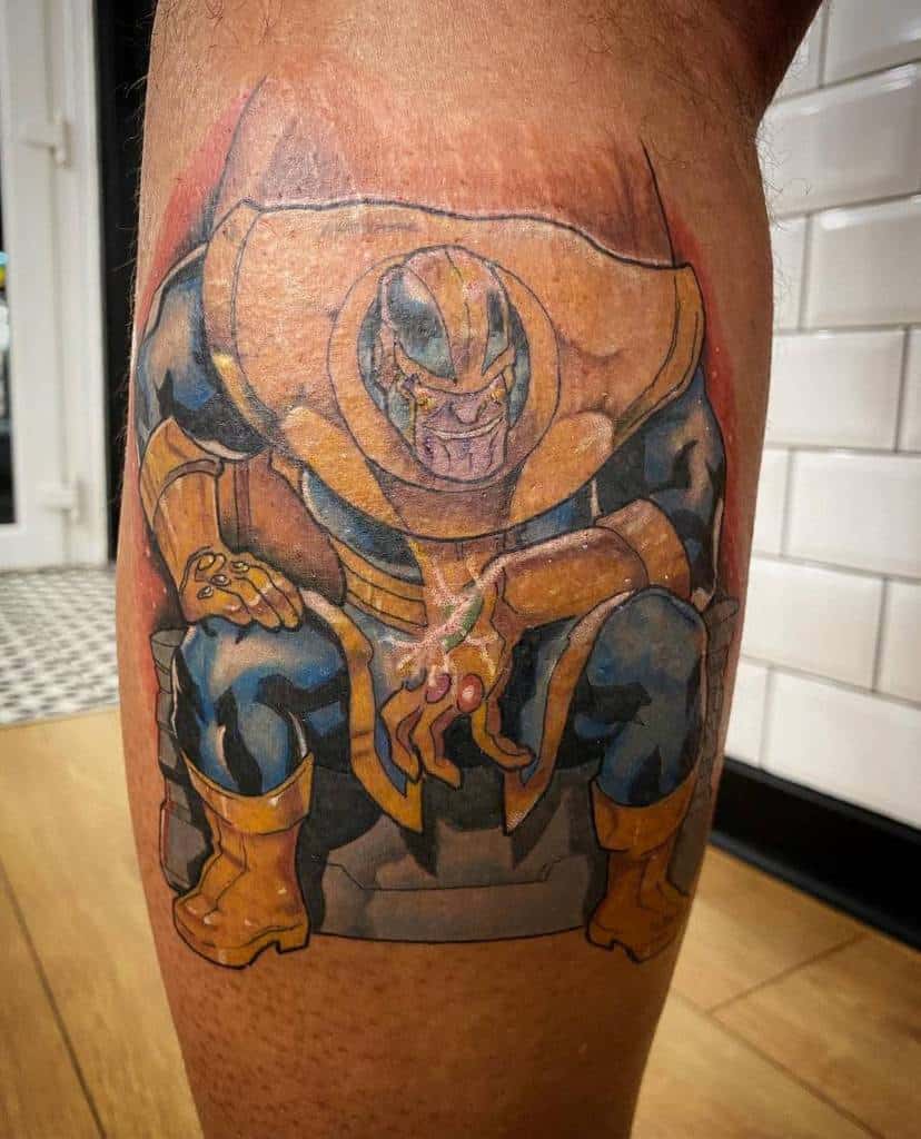Thanos tattoo featuring the Mad Titan sitting on his throne, wearing golden armor and the Infinity Gauntlet with glowing stones