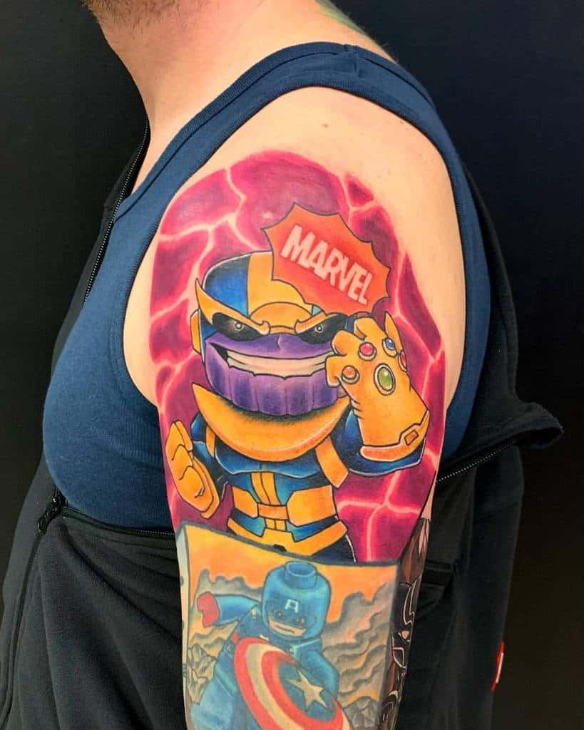 Colorful Thanos tattoo in a cartoon style, featuring the Mad Titan with the Infinity Gauntlet and a bold Marvel logo above his head