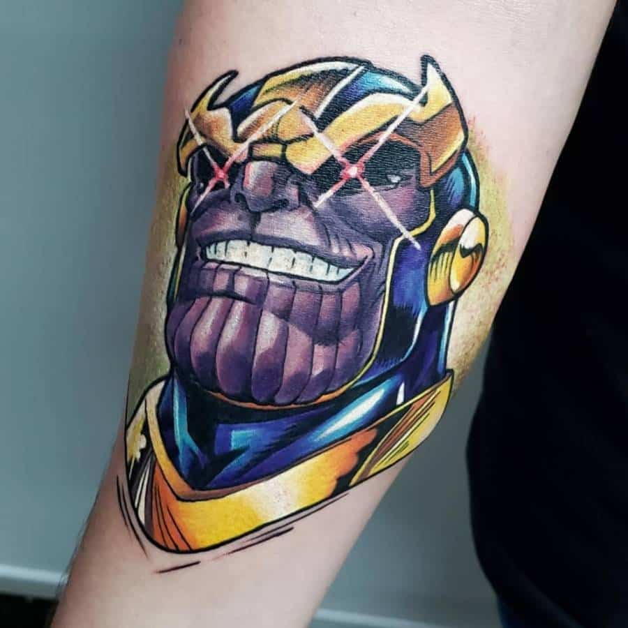 Vibrant Thanos tattoo featuring a menacing grin, glowing red eyes, and his signature golden armor