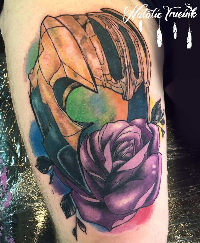 Thanos helmet tattoo with a stunning cosmic background and a vibrant purple rose