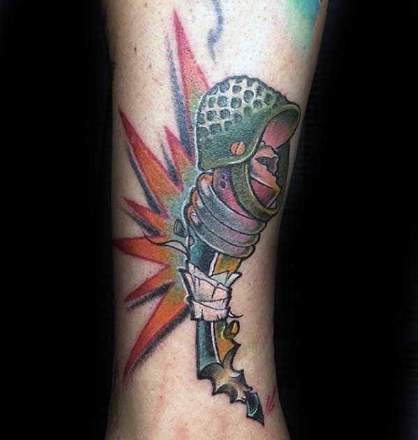 Colorful tattoo of a dynamic pencil with a helmet and vibrant explosion-like background.