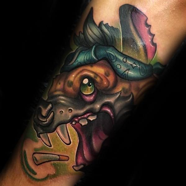 Colorful neo-traditional hyena tattoo featuring exaggerated features, bold outlines, bright green eye, and a bone in its mouth.