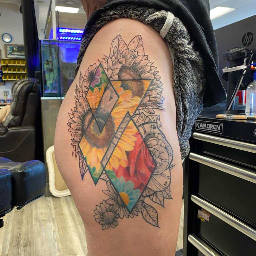 A colorful tattoo features geometric shapes, sunflowers, and a red rose with leaves