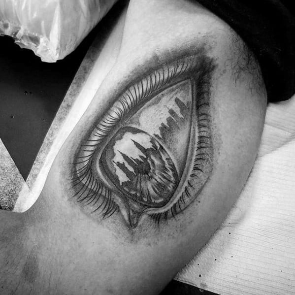Realistic black and gray tattoo of an eye reflecting the New York City skyline, blending surrealism with fine shading and detail.