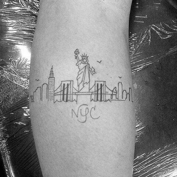 Minimalist NYC tattoo with Statue of Liberty, Brooklyn Bridge, skyline, birds, and “NYC” text in delicate black linework.