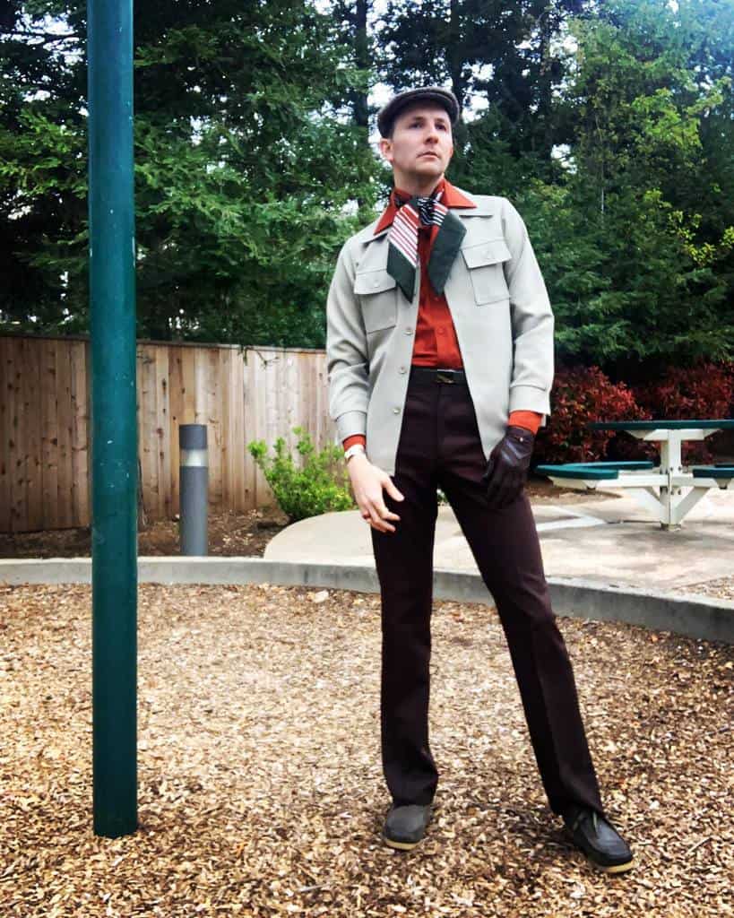 cool gray jacket under is red polo with scarf around neck