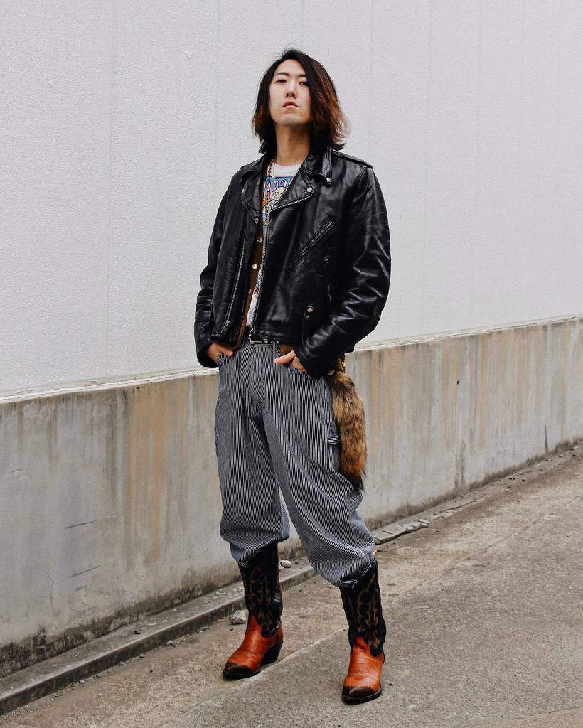 black leather jacket gray pants cool boots in long hair man