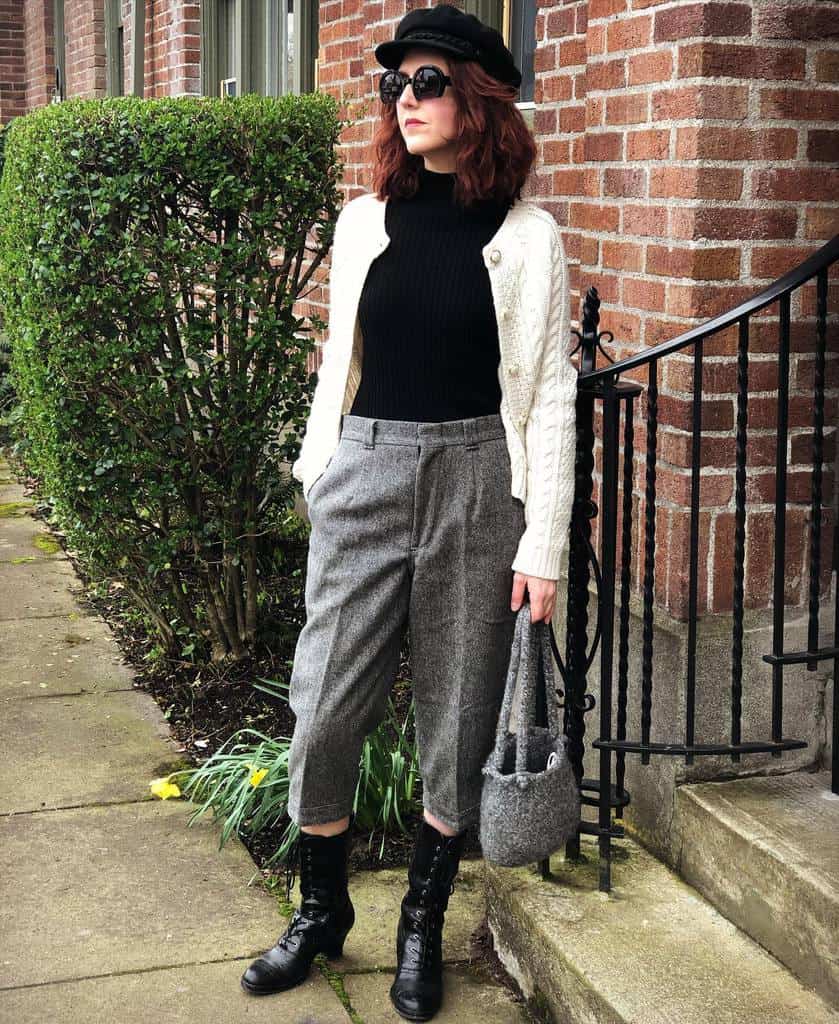 black turtle neck with white kneated jacket gray pants cool bag and shade