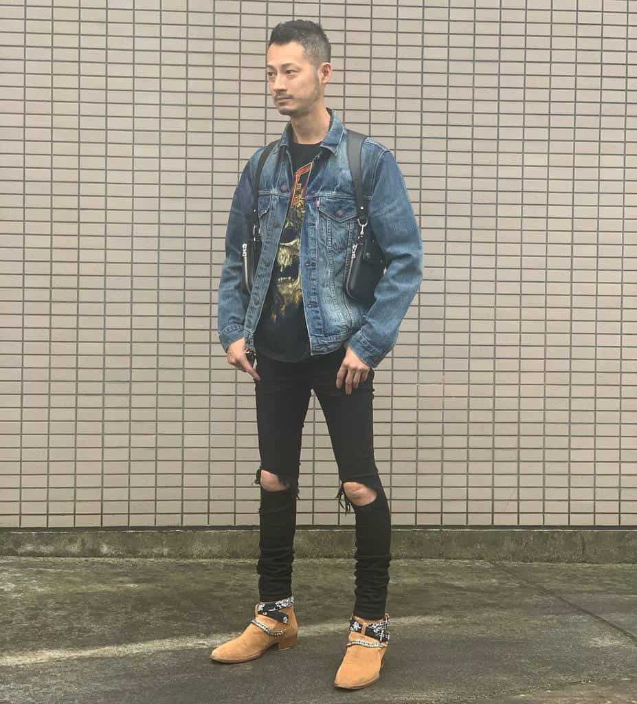 denim jacket under is black printed shirt with ripped jeans and cool shoes