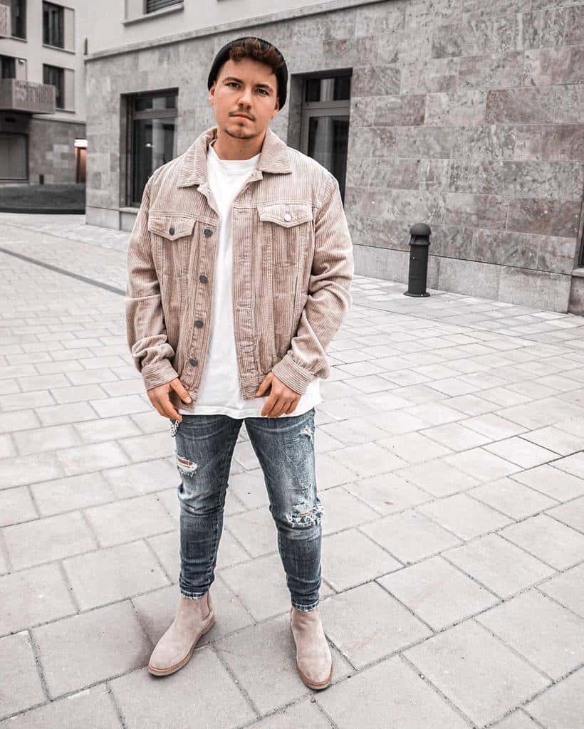 Man wearing distressed denim jeans