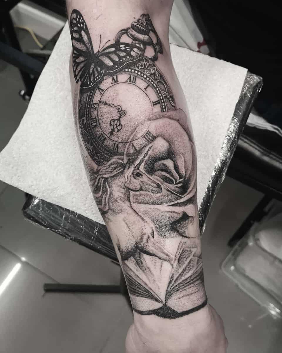 Tattoo of a clock, butterfly, rose, and book on a forearm