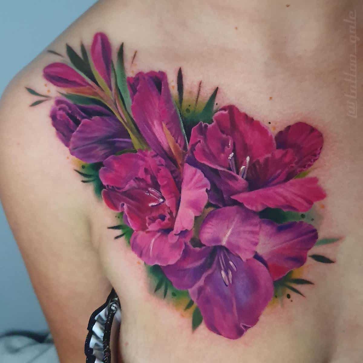 Tattoo of vibrant pink flowers on an upper chest and shoulder