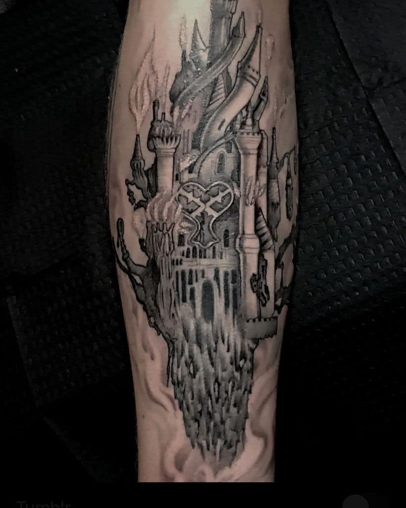 Dark-themed black and grey Kingdom Hearts tattoo of a floating castle with gothic details, featuring a large Heartless emblem at its center.