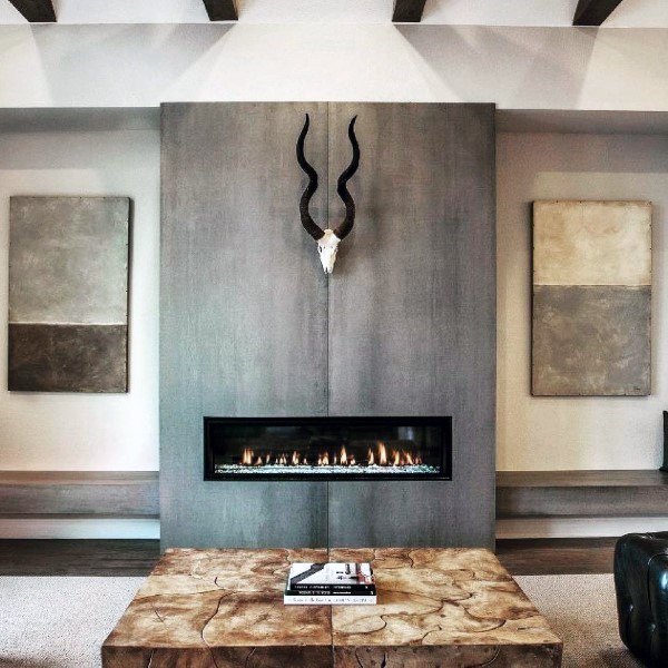 Modern concrete fireplace with a sleek linear design, complemented by rustic decor elements for a bold, balanced look.