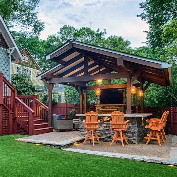 patio with stone fireplace and wood pergola roof