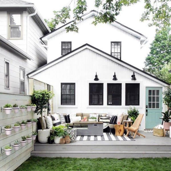 white plank wood privacy fence with pot plants