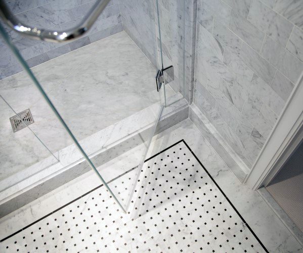 Luxury marble shower with glass door and exquisite mosaic tile flooring