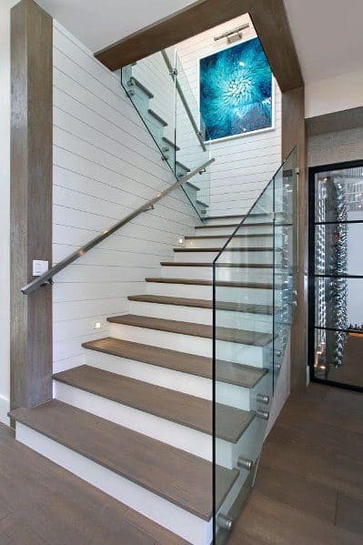 staircase with glass panel railing