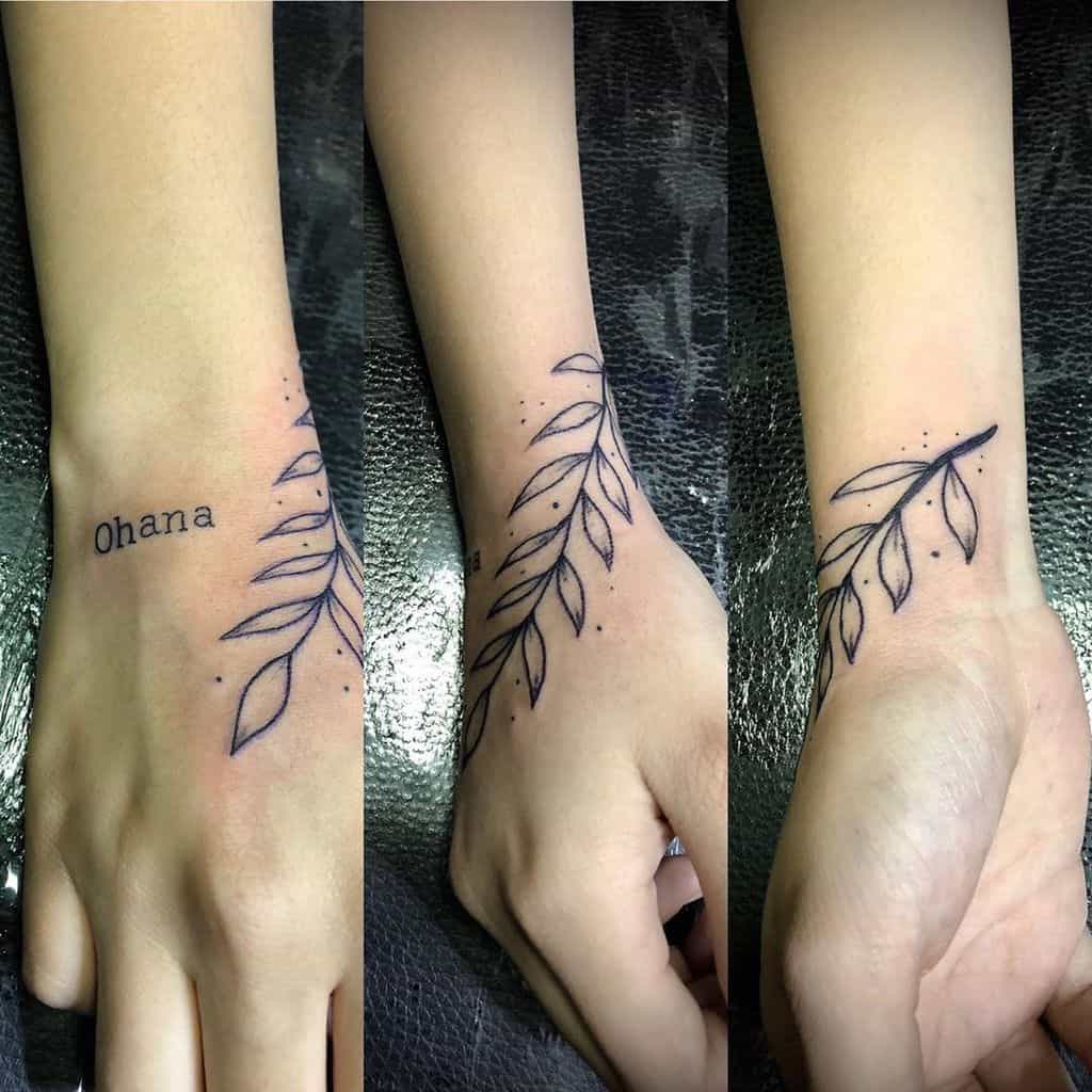 Minimalist tattoo with 'Ohana' and a delicate leaf design, symbolizing family, growth, and connection.