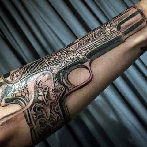 Nicely Engraved Pistol Tattoo On Forearms For Guys