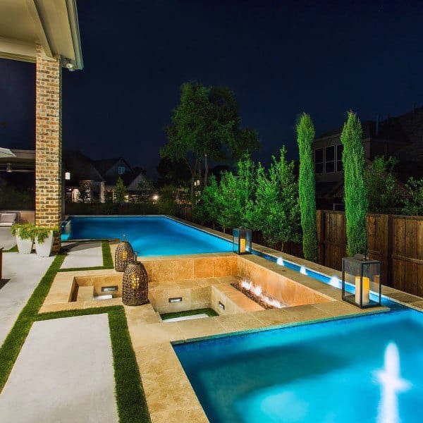 Luxury backyard with glowing pool, built-in fire pit, and elegant lantern decor.