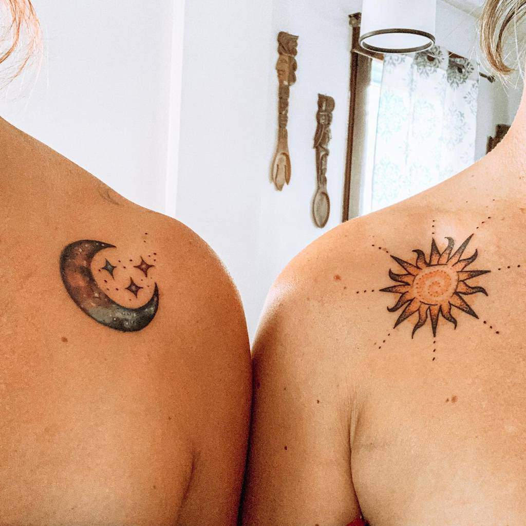 Matching sun and moon sister tattoos one featuring a glowing crescent moon with stars, the other a radiant sun with intricate details