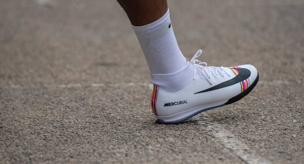 A soccer player in Nike shoes