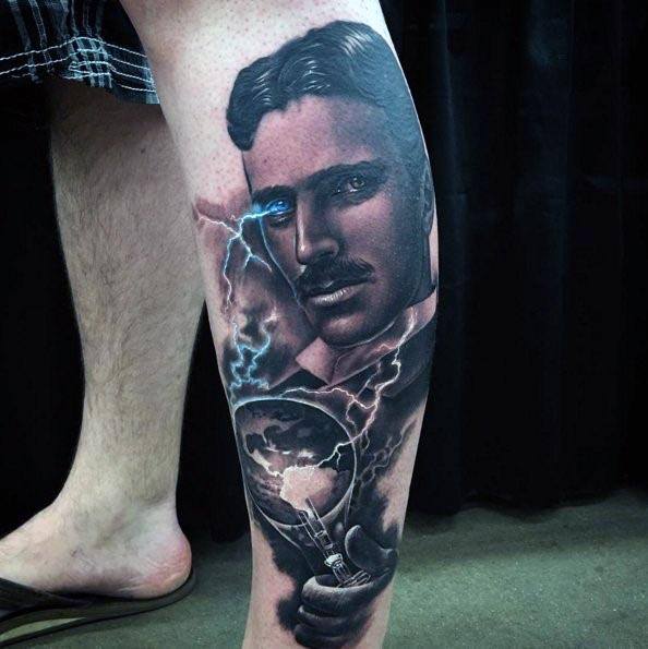 Realistic leg tattoo of Nikola Tesla with glowing blue eyes, lightning, and a hand holding a sparking globe and lightbulb.