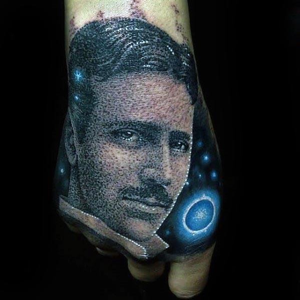 Dotwork tattoo of Nikola Tesla on the hand with cosmic elements, glowing blue orbs, and a textured starry background.