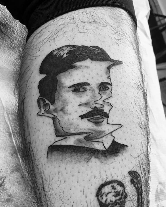Abstract blackwork tattoo of Nikola Tesla with distorted facial features, giving a glitch effect, paired with minimal shading.
