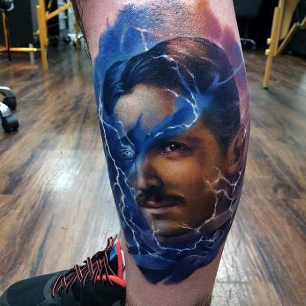 Vibrant color tattoo of Nikola Tesla with a split blue lightning design across his face, creating a dynamic and electrifying effect.