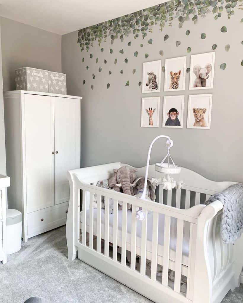 nursery gray walls framed animal drawings white crib white wardrobe