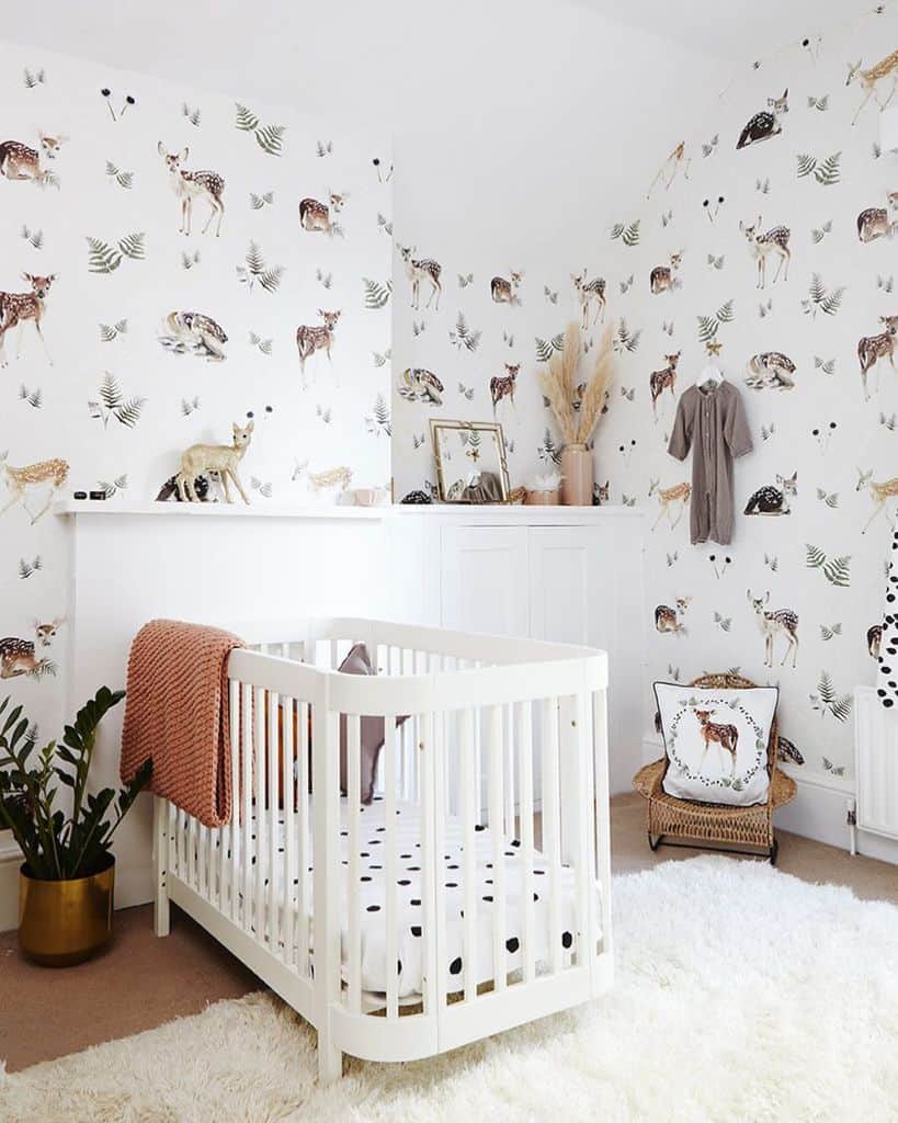 deer wallpaper kids nursery white crib white floor rug wicker chair