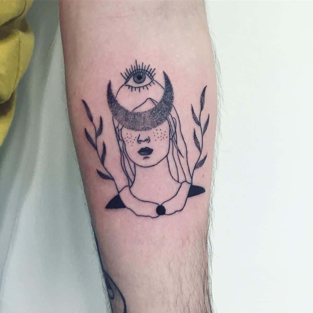 Tattoo of a mystical woman with a crescent moon covering her eyes and an all-seeing eye above, framed by leaves, inked on the forearm.