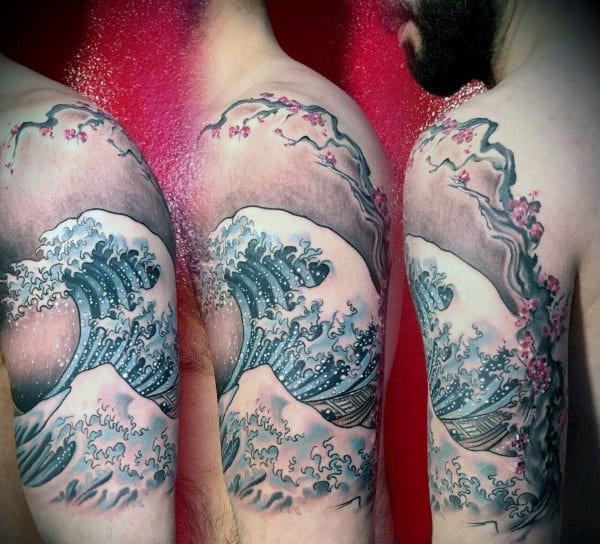 Japanese-style half-sleeve tattoo featuring The Great Wave, Mount Fuji, and cherry blossom branches, blending traditional and modern art styles
