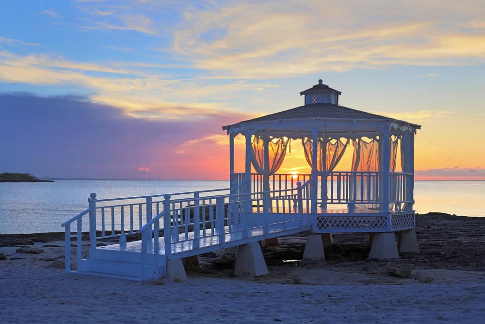 white octagon gazebo with decking ocean view sunrise
