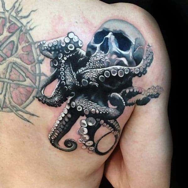 Tattoo of an octopus holding a skull on a person's shoulder blade
