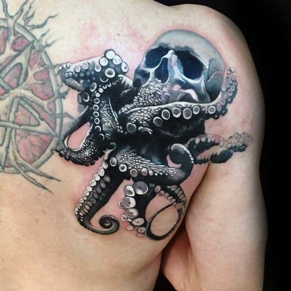 Arm tattoo of a skull entwined with an octopus on the upper arm