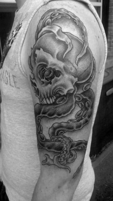 Skull entwined with octopus tentacles, detailed with black shading and smooth gradients, creating a bold, dark tattoo design on the arm.