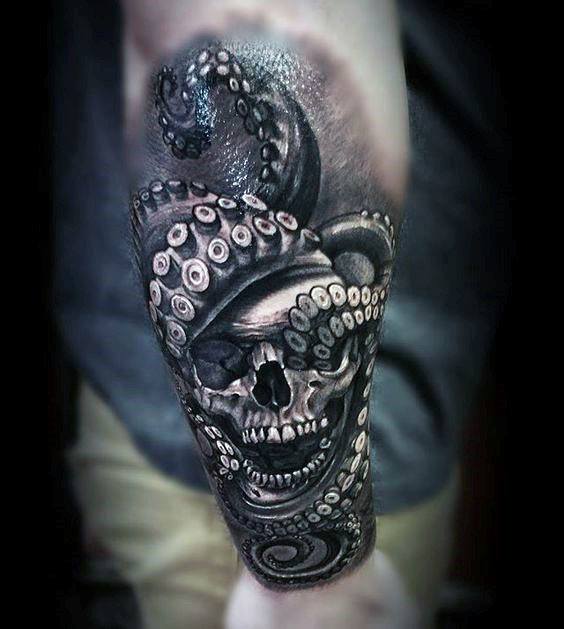 Skull surrounded by octopus tentacles, with intricate shading and highlights, creating a dark and bold black-and-grey design on the forearm.