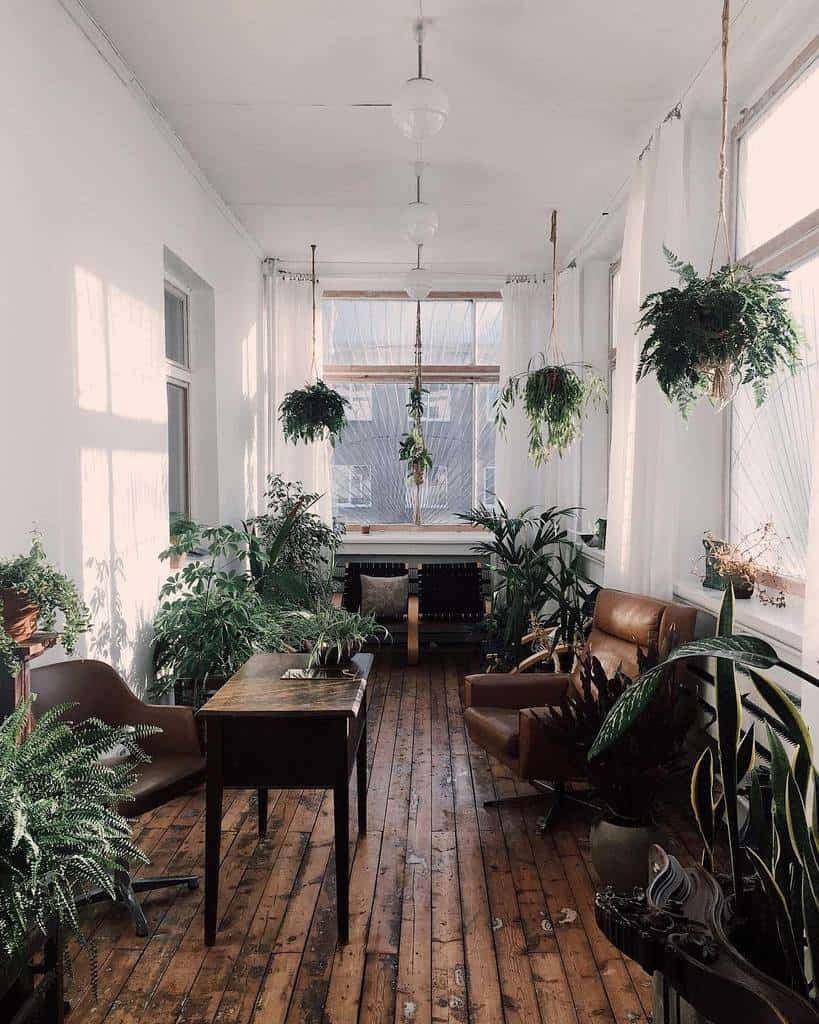 boho living room vintage table accent leather chair hanging plants pot plants hardwood floor