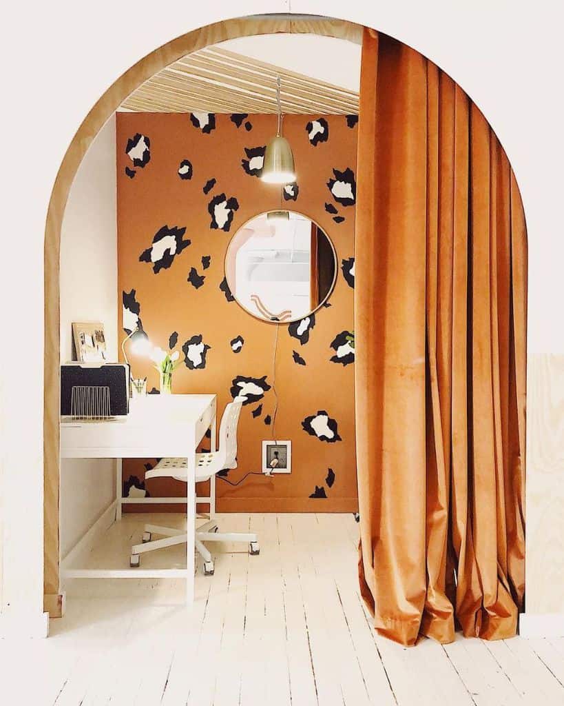 tiger pattern wallpaper orange curtains wood floor white desk and chair wall mirror